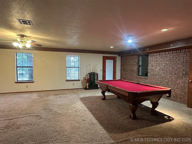 rec room featuring brick wall, a textured ceiling, ceiling fan, billiards, and carpet floors