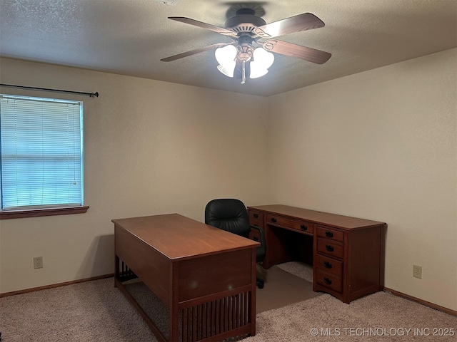 office with a textured ceiling, ceiling fan, and light carpet