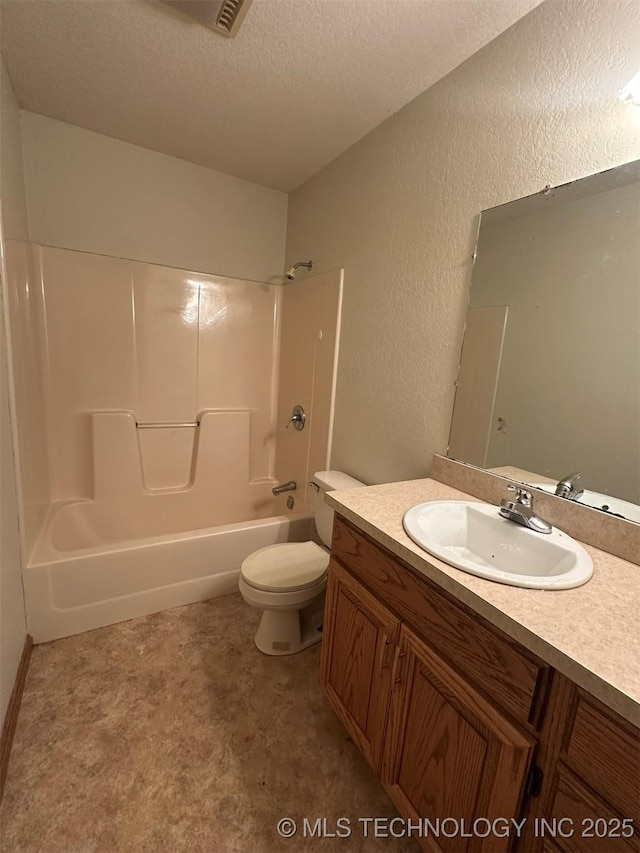 full bathroom featuring shower / bathing tub combination, vanity, toilet, and a textured ceiling