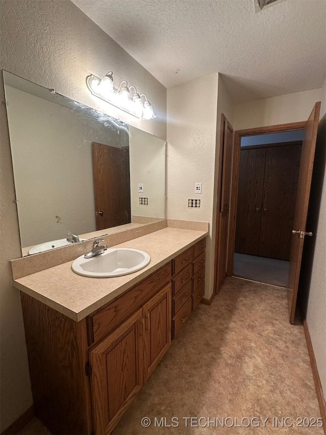 bathroom with vanity and a textured ceiling