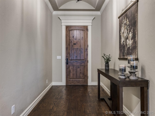 foyer with baseboards, wood finished floors, and crown molding