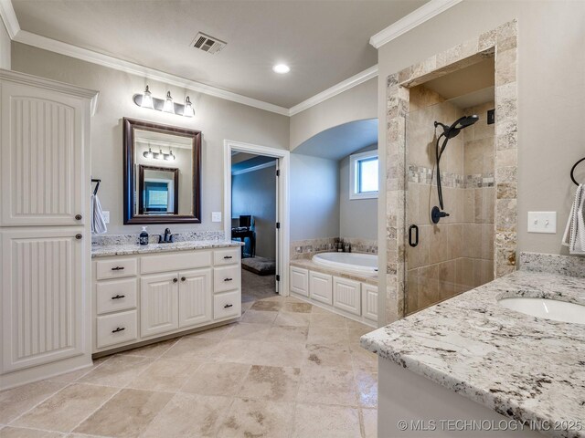 bathroom featuring plus walk in shower, ornamental molding, and vanity