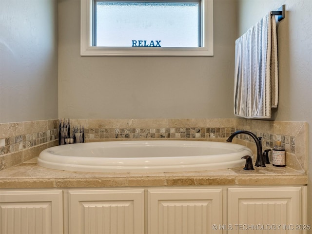 bathroom with a bath and a healthy amount of sunlight