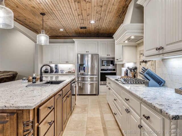 kitchen with a sink, custom range hood, appliances with stainless steel finishes, wooden ceiling, and tasteful backsplash