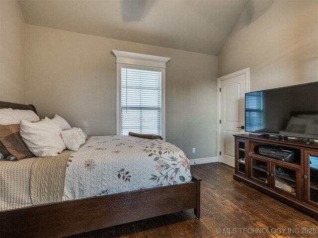 bedroom with lofted ceiling and dark hardwood / wood-style floors