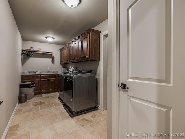 laundry area featuring cabinets and washing machine and clothes dryer