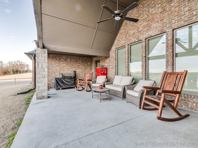 view of patio with an outdoor living space and a ceiling fan