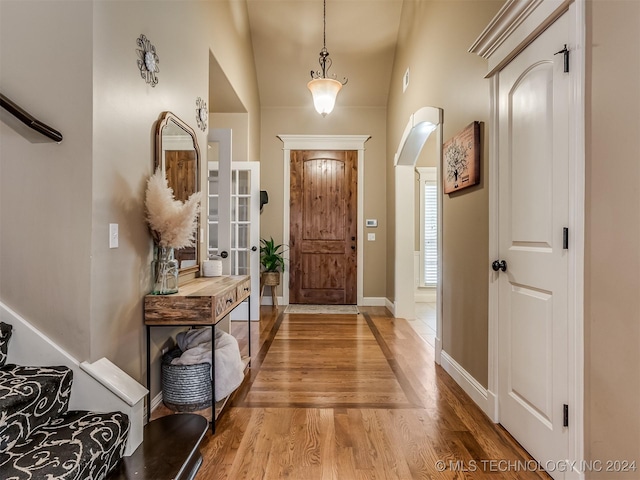 entrance foyer with light hardwood / wood-style floors and lofted ceiling