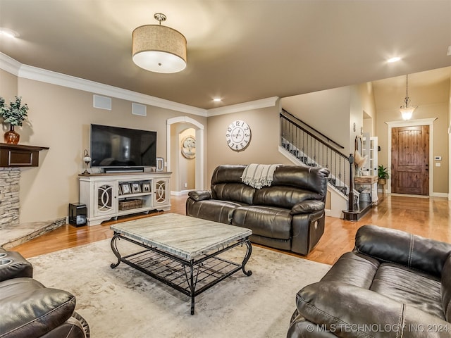 living room with ornamental molding and wood-type flooring