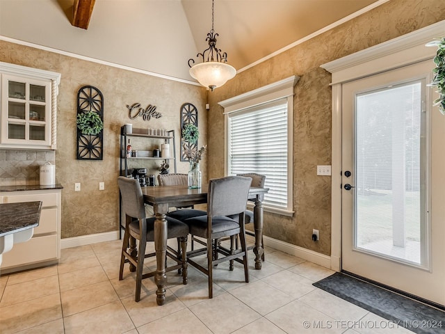 tiled dining space featuring vaulted ceiling