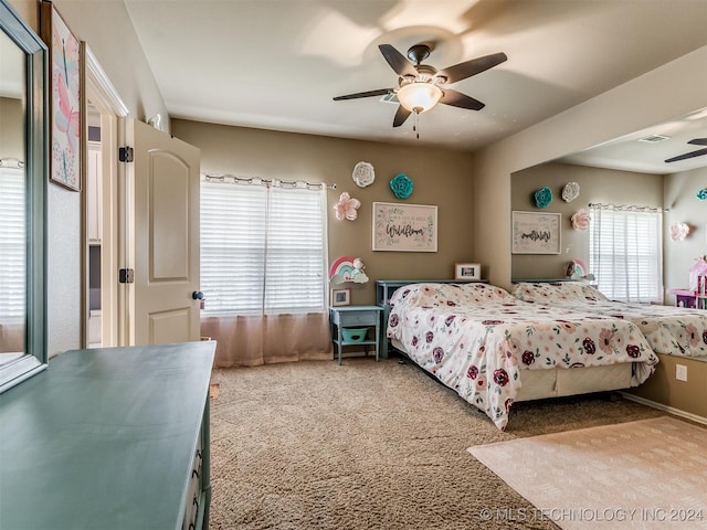 bedroom featuring ceiling fan, carpet flooring, and multiple windows