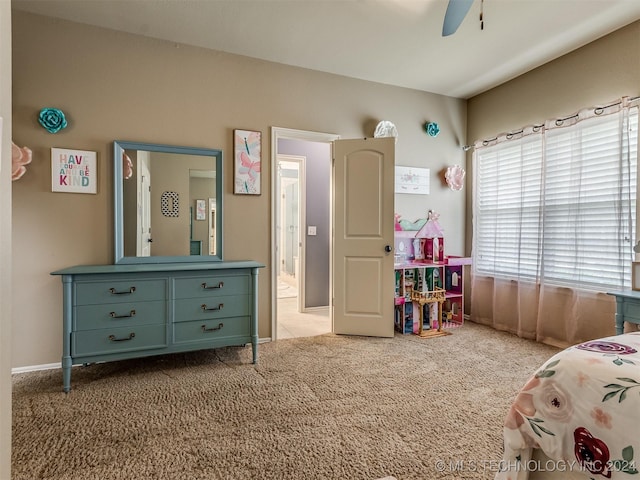 bedroom featuring ceiling fan and light carpet