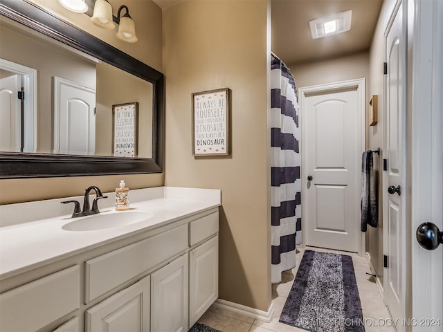 bathroom with tile patterned floors and vanity