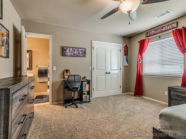 carpeted bedroom featuring ceiling fan and a closet