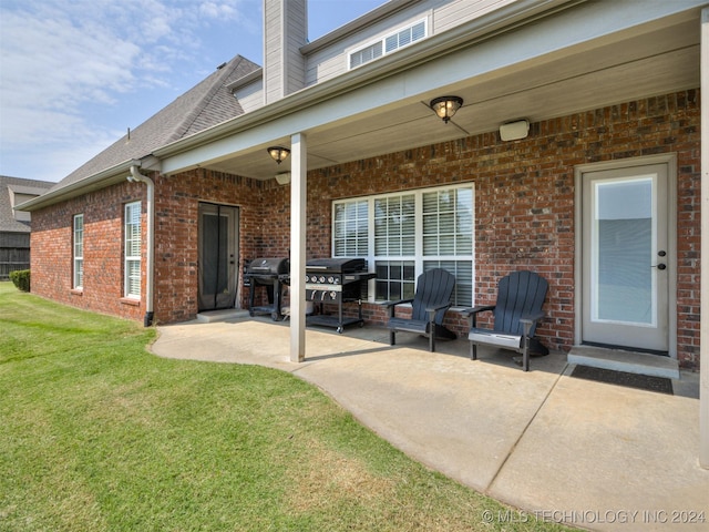 back of property with a lawn and a patio