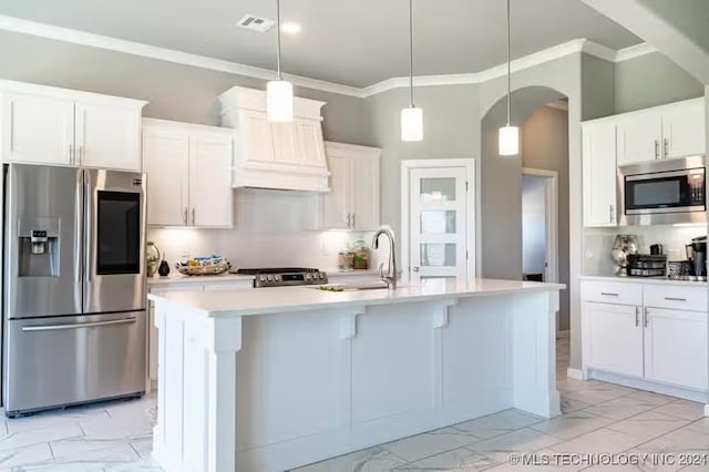 kitchen featuring a center island with sink, white cabinets, decorative light fixtures, and appliances with stainless steel finishes