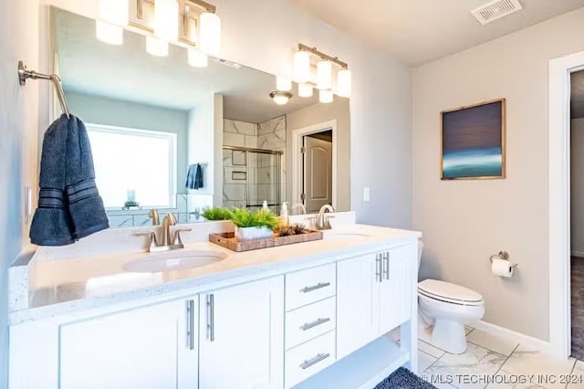 bathroom with toilet, vanity, and walk in shower