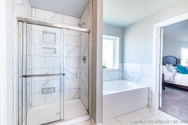 bathroom with shower with separate bathtub