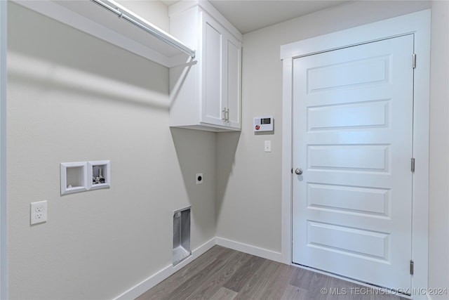 clothes washing area featuring hookup for an electric dryer, washer hookup, dark wood-type flooring, and cabinets