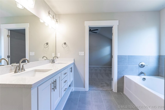 bathroom featuring vanity, a bathtub, tile patterned floors, and ceiling fan