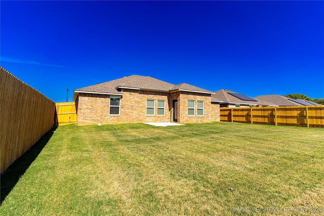 rear view of house with a yard