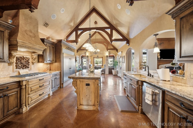 kitchen with appliances with stainless steel finishes, arched walkways, an inviting chandelier, open floor plan, and high vaulted ceiling