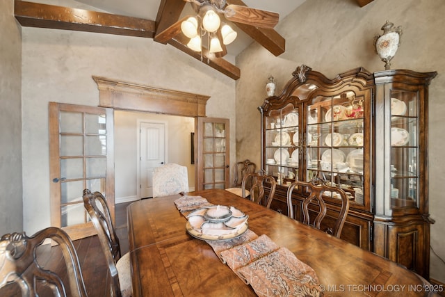 dining space with ceiling fan, beam ceiling, and high vaulted ceiling