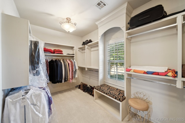 walk in closet featuring visible vents and carpet floors