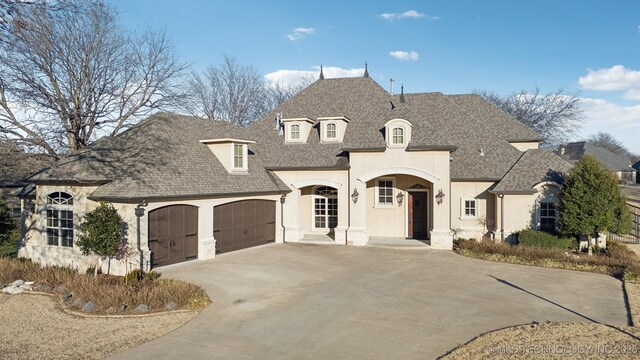 french country style house featuring a garage