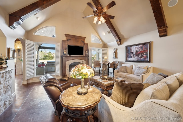 living area featuring arched walkways, ceiling fan, beamed ceiling, a fireplace, and high vaulted ceiling