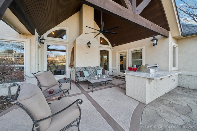 view of patio / terrace with a ceiling fan, an outdoor hangout area, exterior kitchen, and outdoor wet bar