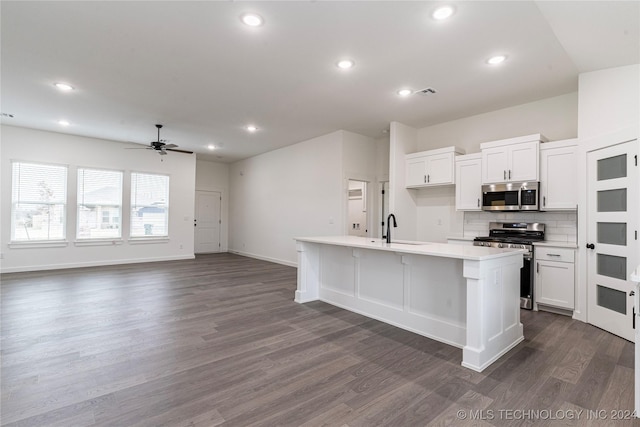 kitchen featuring sink, stainless steel appliances, dark hardwood / wood-style floors, a kitchen island with sink, and white cabinets