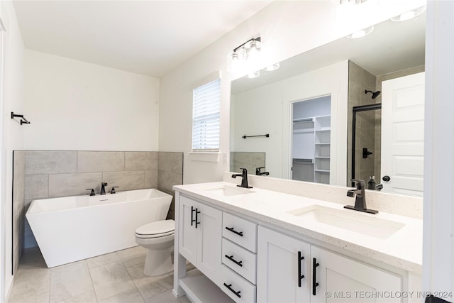 full bathroom with toilet, shower with separate bathtub, vanity, and tile patterned floors