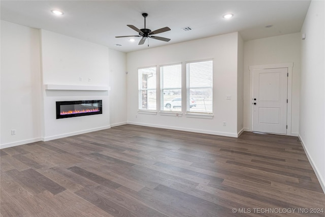 unfurnished living room with ceiling fan and dark hardwood / wood-style floors