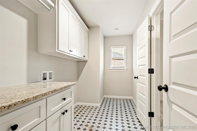 laundry room featuring hookup for a washing machine and cabinets