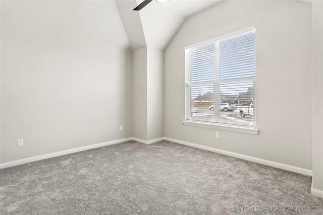 empty room with ceiling fan, carpet floors, and lofted ceiling