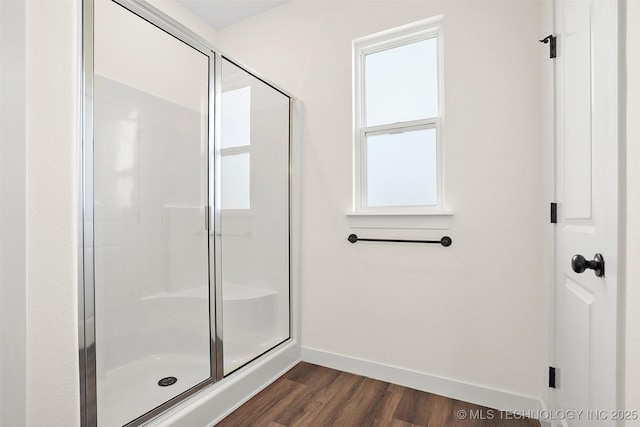 bathroom featuring hardwood / wood-style flooring and a shower with door