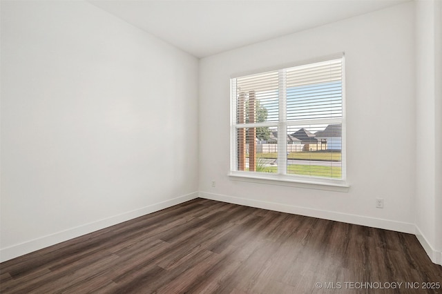 unfurnished room with dark hardwood / wood-style floors