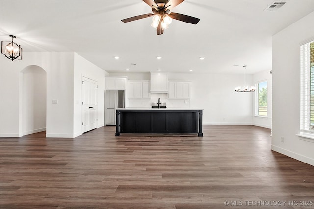 kitchen featuring white cabinetry, dark hardwood / wood-style flooring, an island with sink, and sink