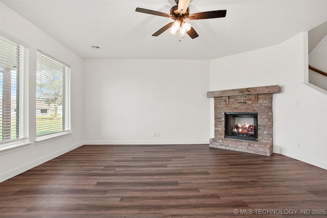 unfurnished living room with ceiling fan, a fireplace, and dark hardwood / wood-style floors