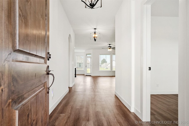 hallway featuring a chandelier and dark hardwood / wood-style floors