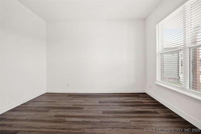 unfurnished room with dark hardwood / wood-style flooring