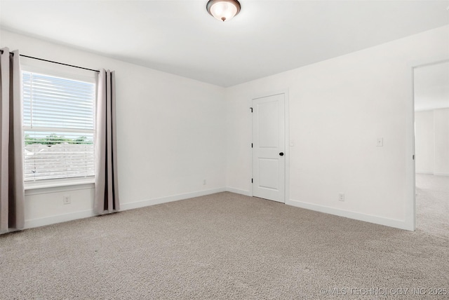 empty room featuring a healthy amount of sunlight and light colored carpet