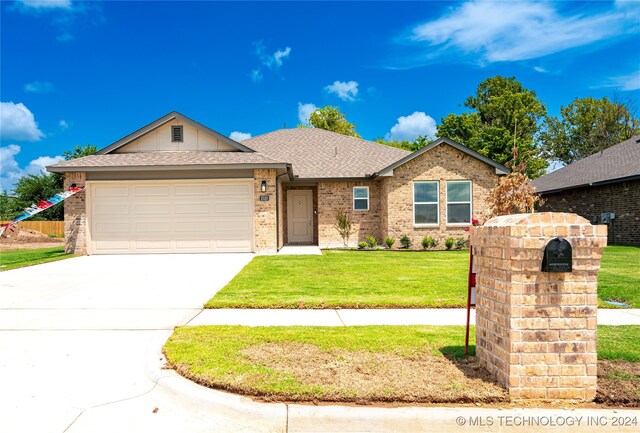 view of front of home featuring a garage and a front yard