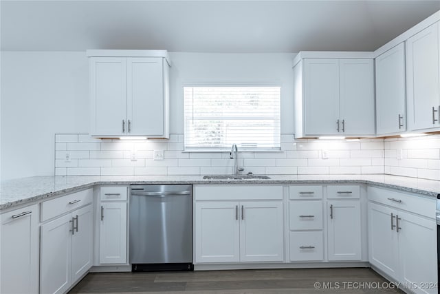 kitchen featuring dishwasher, light stone counters, white cabinetry, and sink