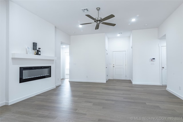 unfurnished living room featuring ceiling fan and hardwood / wood-style floors