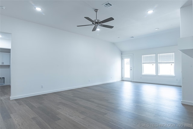 spare room with dark hardwood / wood-style floors, ceiling fan, and lofted ceiling