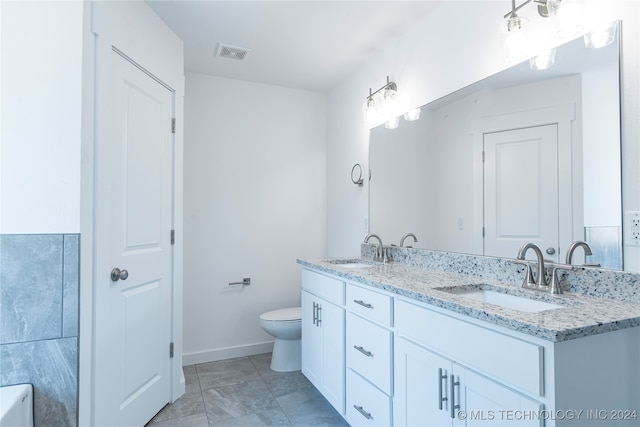 bathroom featuring vanity and toilet