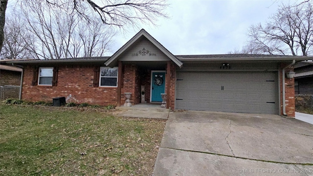 single story home with a garage and a front lawn