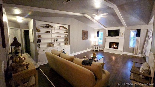 living room featuring dark hardwood / wood-style flooring, vaulted ceiling with beams, built in shelves, and ceiling fan